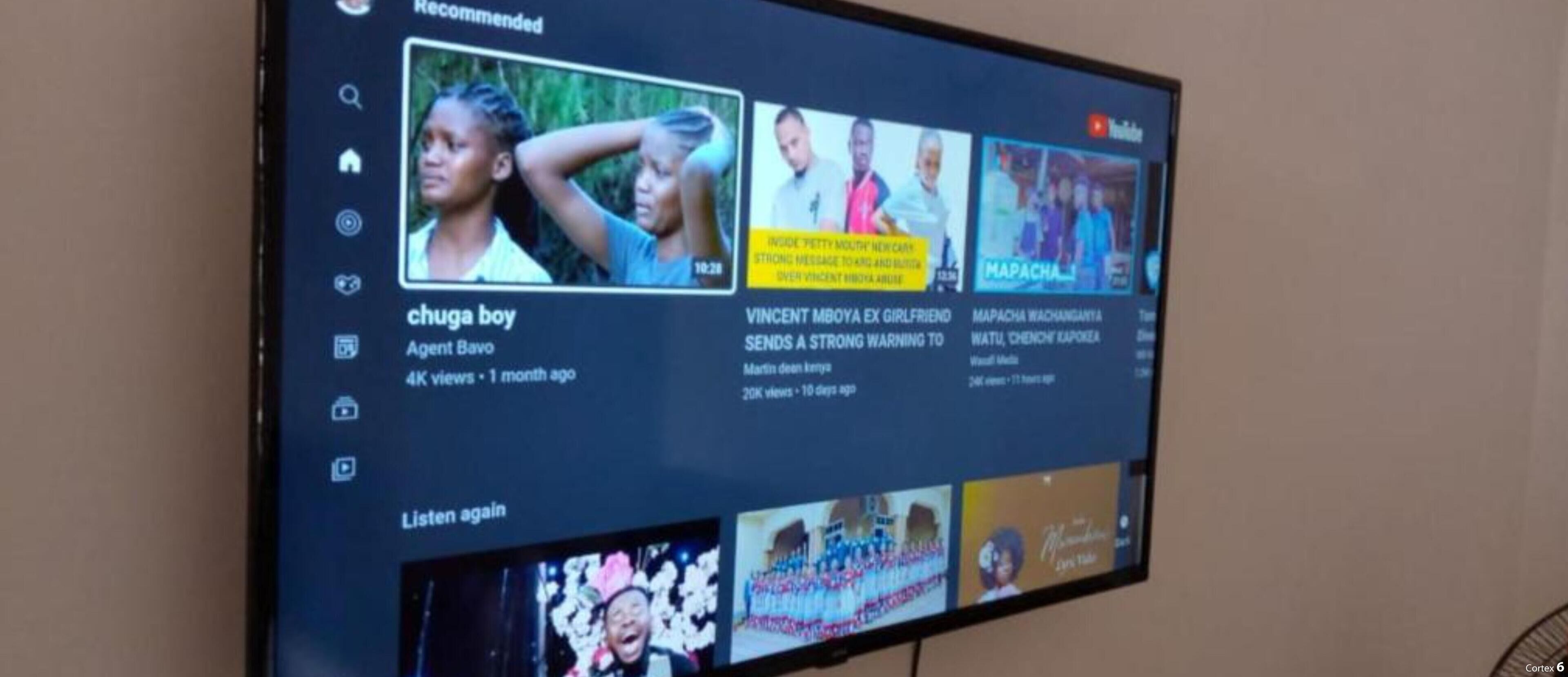 A television screen displaying a YouTube channel with various video thumbnails and titles.