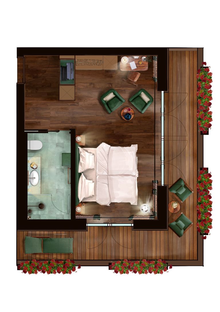 Vue plongeante d’une pièce comprenant un lit, une petite salle de bain, un coin salon avec une table et des chaises, et une terrasse en bois agrémentée de fleurs.