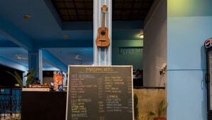 A menu board with various food and beverage options in a restaurant setting. - Madpackers Udaipur (Udaipur)