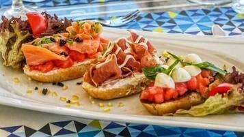 A plate of bruschetta with various toppings.