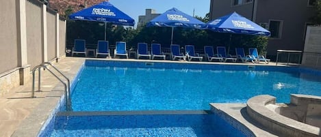 Seasonal outdoor pool, pool umbrellas, pool loungers