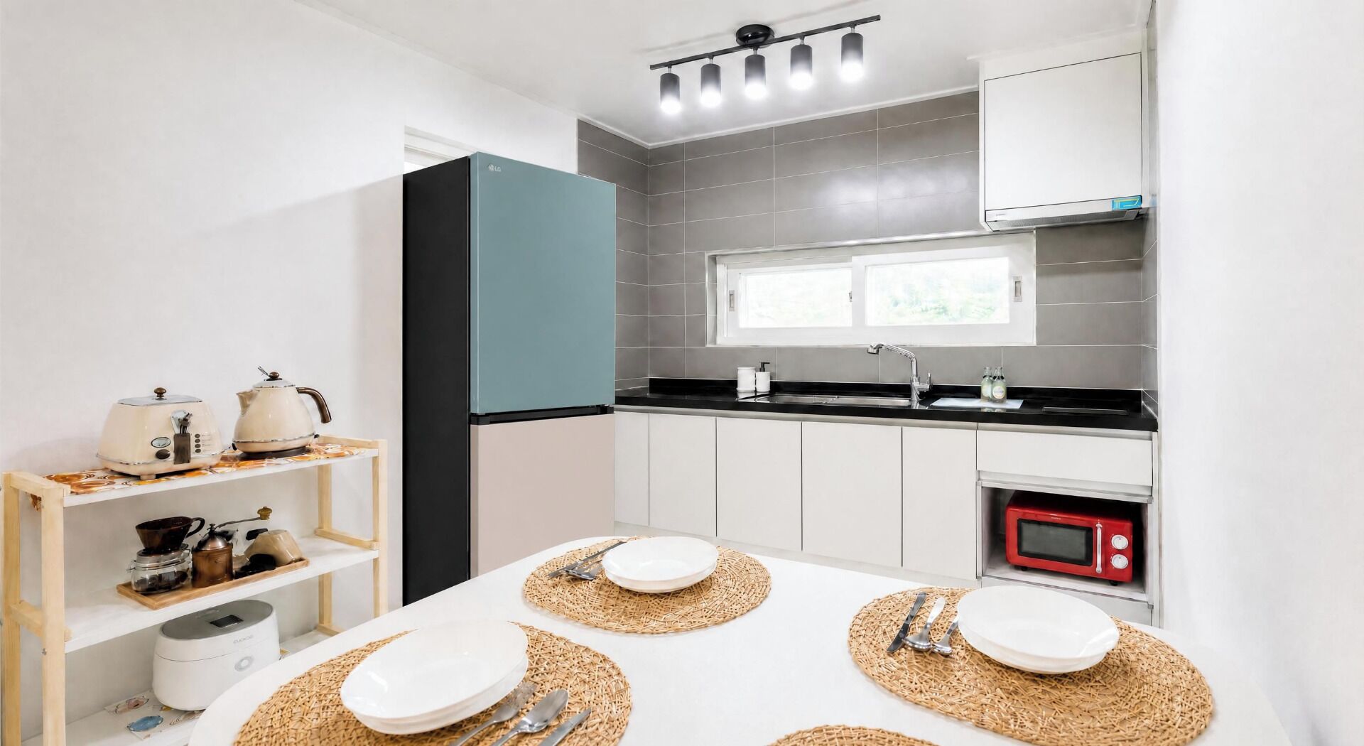 A modern kitchen with a microwave, sink, and cabinets.