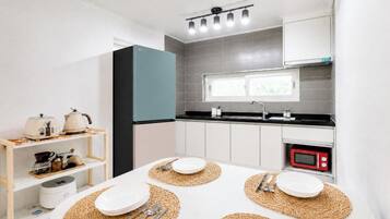 A modern kitchen with a microwave, sink, and cabinets.