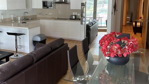 A modern kitchen with white cabinets, stainless steel appliances, and a central island. - Britain in the Sun at Luxurious Ocean Village (Gibraltar)