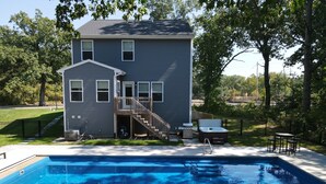 A two-story house with a front deck, a hot tub, and a swimming pool. - Heated Private Pool, Spacious, Hot Tub All Year (New Buffalo)