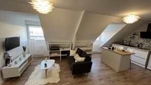 A modern loft apartment with a living area, kitchenette, and dining space. - Studio Scandinave - Duplex - Hyper Centre (Lorient)