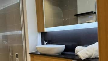 Combined shower/bathtub, deep-soaking bathtub, towels