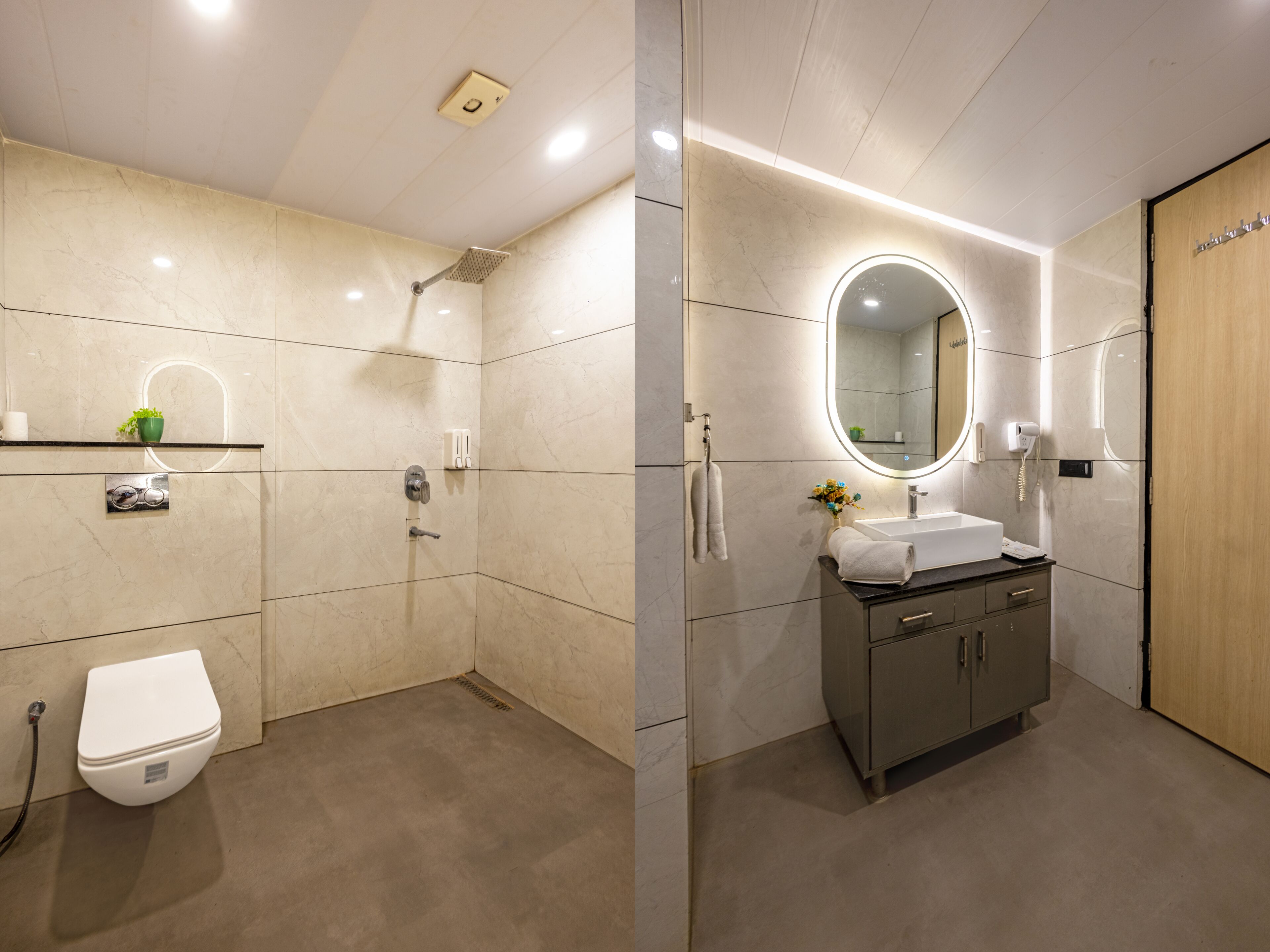 A modern bathroom with a toilet, shower, vanity with a mirror, and a sink.