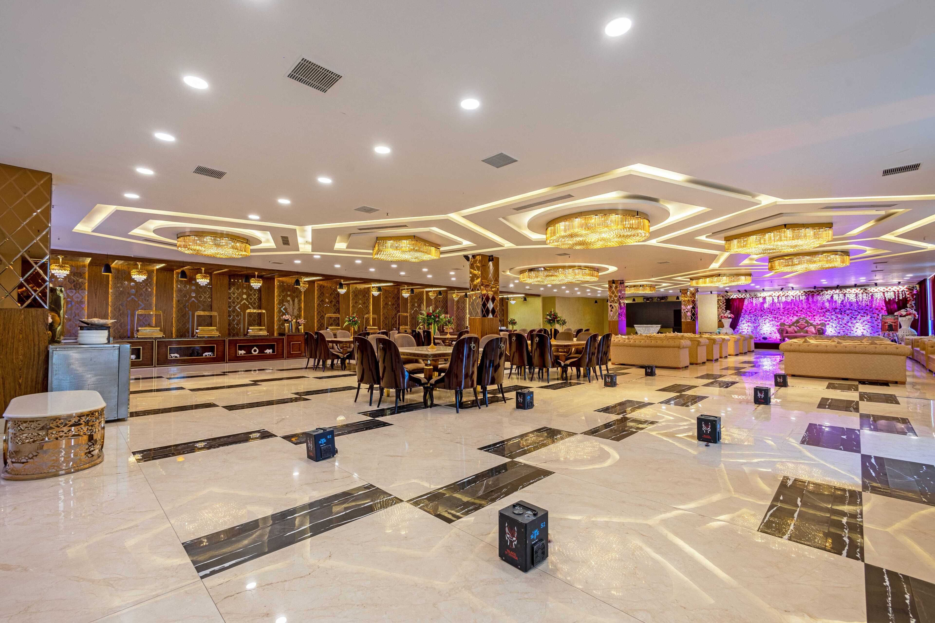 A spacious hotel lobby with a checkered floor, multiple dining tables, and elegant chandeliers.