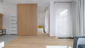 A modern living room with a wooden wardrobe, a sofa, and a coffee table.