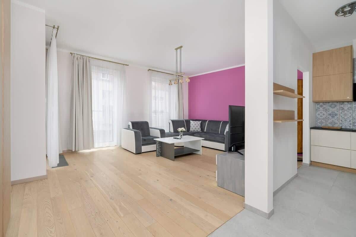 A modern living room with a sofa set, a coffee table, and a TV.