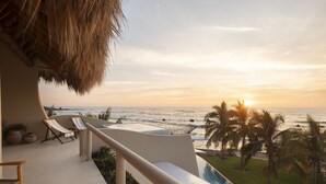 A balcony with a view of the ocean at sunset, lounge chairs, and a pool. - Los Panchos (Saladita)