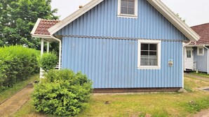 A blue house with a small porch and a number '3' on the side. - New! Haus Seebrise - at Useriner See - Müritz National Park (Userin)