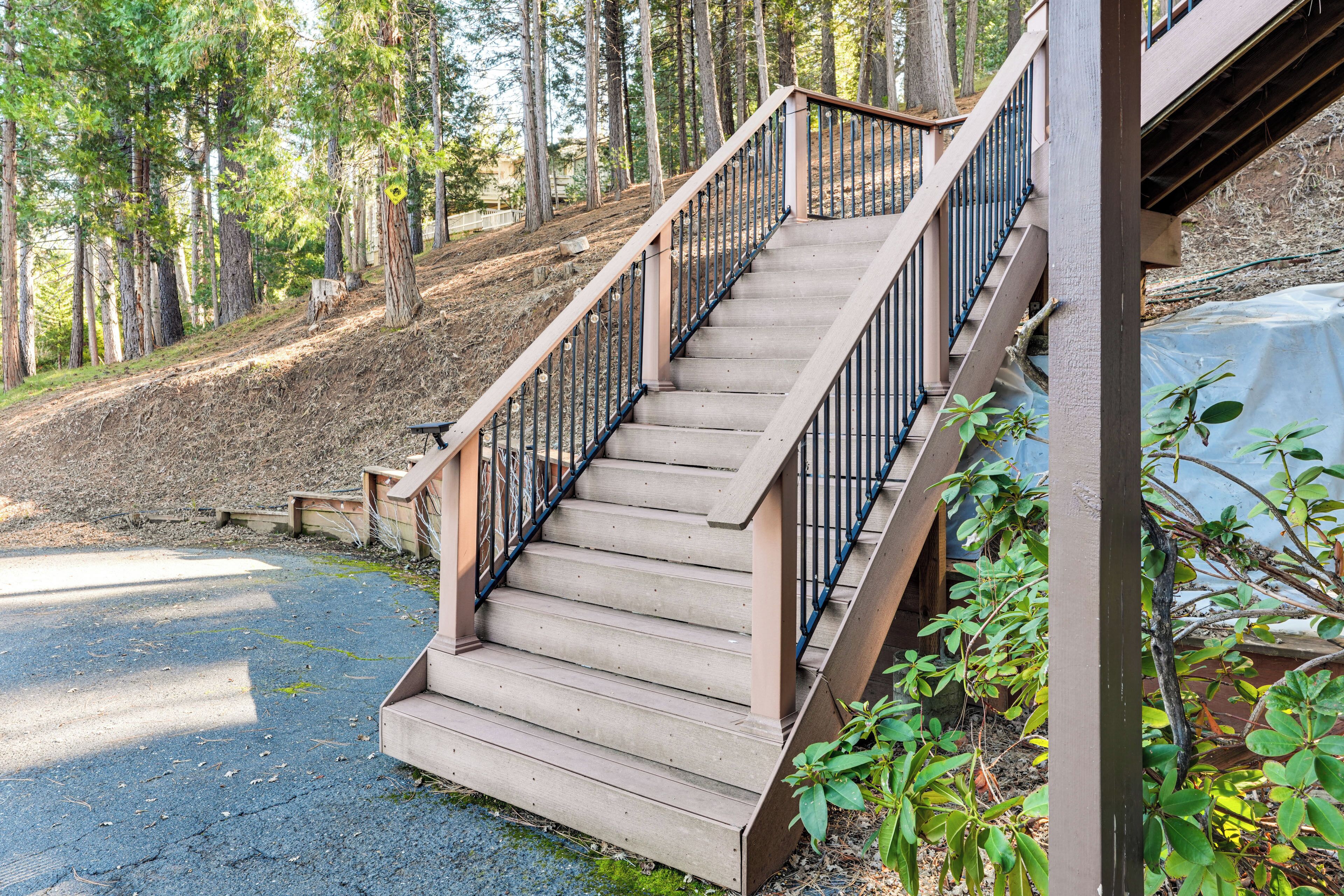 A wooden staircase with metal railings leading to a building.