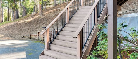 A wooden staircase with metal railings leading to a building.