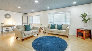 A spacious living room with two sofas, a coffee table, and a blue rug. - Pool & Game Room: Spacious Brandon Home (Brandon)