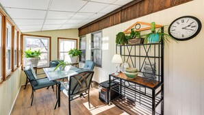 A dining area with a glass table, chairs, and potted plants. - Classic Country Retreat in Ronda on 5 Acres! (Ronda)