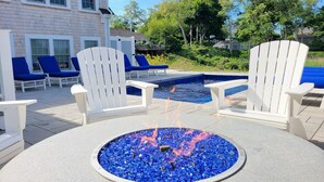 A poolside area with Adirondack chairs, a fire pit, and a swimming pool. - Stroll to Chatham's Popular Shops & Dining / Or Walk to Andrew Hardings Beach from This NEW Impeccable Compound (Chatham)