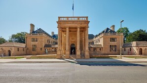 A large, historic building with a prominent entrance, multiple windows, and a flagpole. - Rhodes House (Oxford)