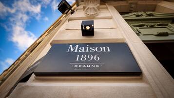 A sign with the text "Maison 1896 Beaune" on a building facade.
