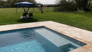 A rectangular swimming pool with clear water, surrounded by a tiled deck. - Château de la Preuille (Montaigu-Vendée)