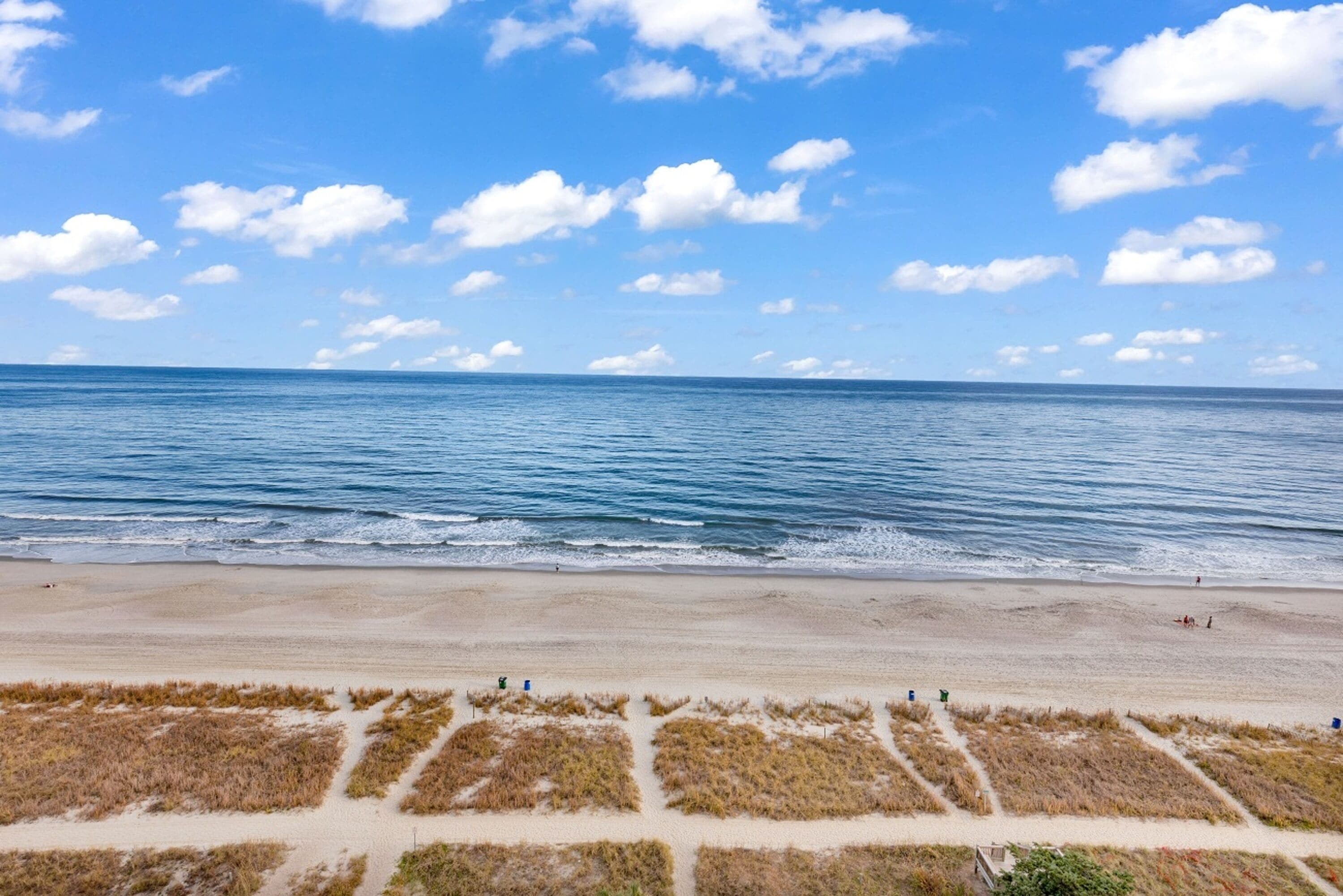 A beach with clear skies and calm waters.