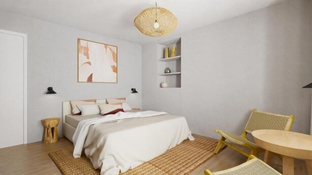 A modern bedroom with a bed, bedside tables, a chair, a small table, and a hanging light fixture. - Appartement - Vue sur Mer (Collioure)