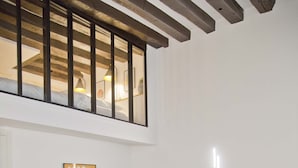 Uma sala de estar moderna com um sofá seccional, dois pufes e uma mesa de centro.