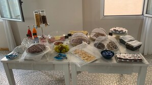 A buffet table with various food items and condiments. - Hotel Teti (Ugento)
