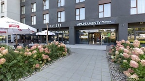 Ein modernes Gebäude mit einem Schild 'Apartment' und einem Schild 'Restaurant'.