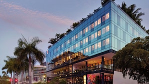 A modern hotel with a glass facade, multiple floors, and balconies. - citizenM Miami South Beach (Miami Beach)