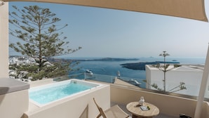 A balcony with a pool, wicker furniture, and a view of the sea and distant islands. - Morfes Luxury Suites by Caldera Houses (Santorini)