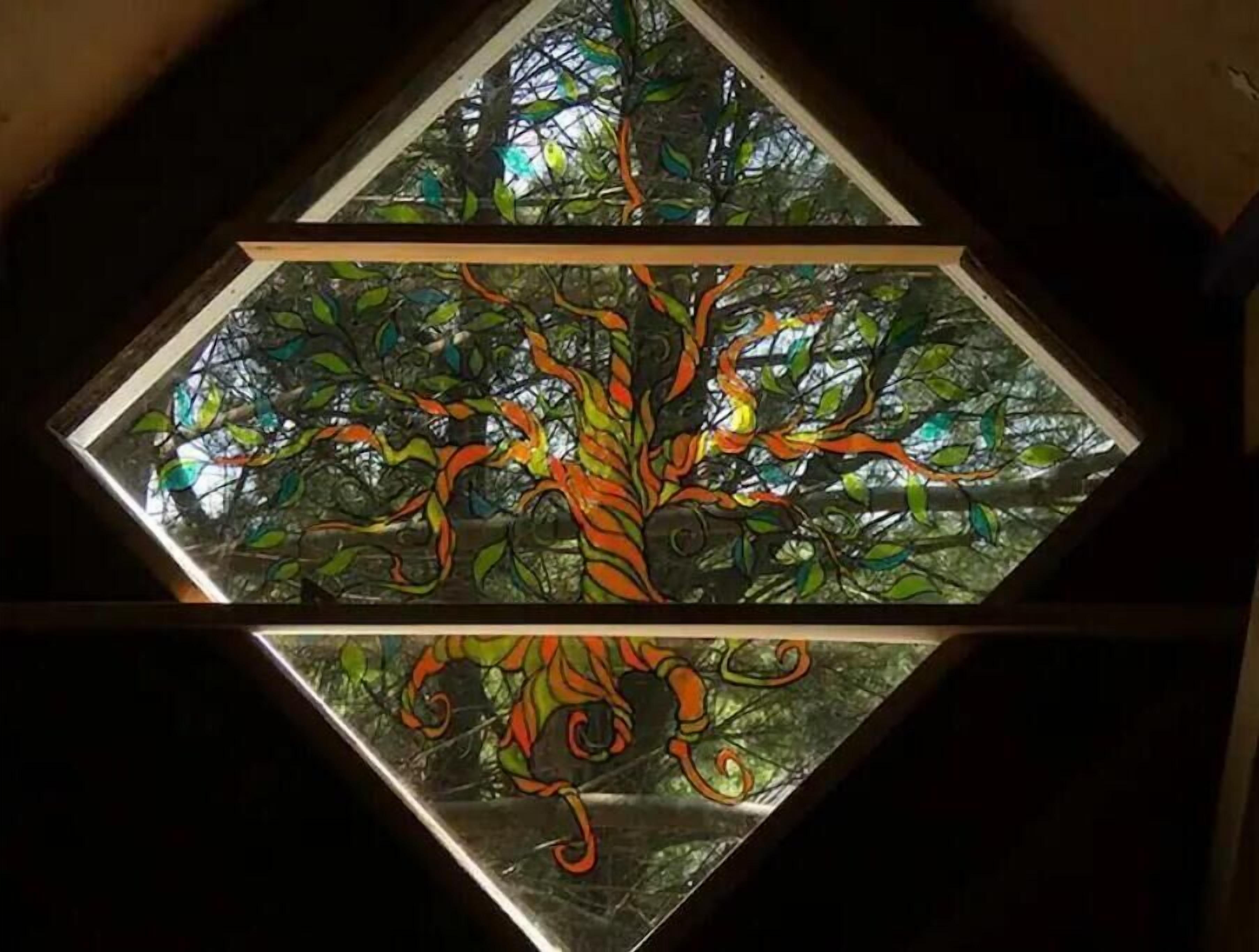 A stained glass window with a tree design.