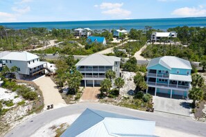 A coastal residential area with houses, a road, and a beach. - Cape Dreamin' (Port St. Joe)