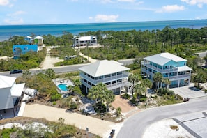A coastal property with a pool, multiple buildings, and a view of the ocean. - Cape Dreamin' (Port St. Joe)