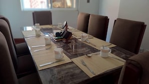 A conference room with a long table set for a meeting.