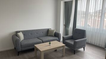 Deluxe Apartment | Living area | 40-inch Smart TV with cable channels