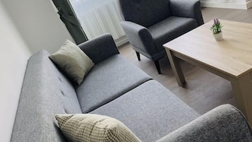 Deluxe Apartment | Living area | 40-inch Smart TV with cable channels