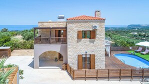 A stone villa with a pool, a balcony, and a view of the sea. - Villa Ourania Klio - Two Bedroom Villa, Sleeps 4 (Crete)