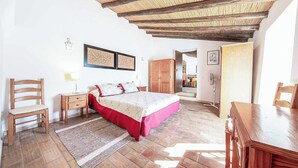 A bedroom with a bed, a wooden chair, a nightstand, a desk, and a wardrobe. - Casa Nomanico - Two Bedroom Villa, Sleeps 4 (Estoi)