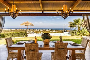 Enjoy a romantic meal under the stars with a breathtaking ocean view from this outdoor dining area.