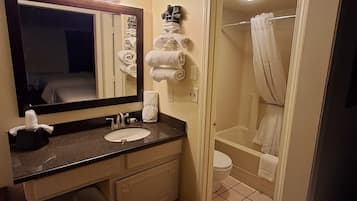 Eenvoudige tweepersoonskamer | Badkamer | Een bad/douchecombinatie, handdoeken, toiletpapier