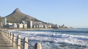 A coastal cityscape with a prominent mountain, a beach promenade, and a view of the ocean. - Sandringham 55 - Studio Apartment, Sleeps 2 (Cape Town)