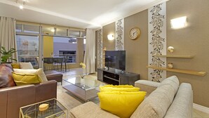 A modern living room with a sofa, coffee table, and TV.