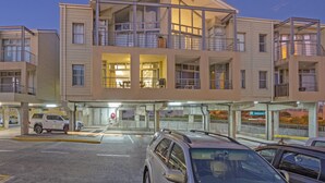 A multi-story parking garage with a modern design, featuring multiple levels and a covered entrance.