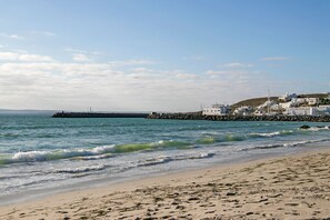 Enjoy a serene beachside retreat with a breakwater separating the shore from the calm waters.