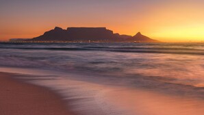 A beach with a mountain in the background. - Sea Spray B306 - Two Bedroom Apartment, Sleeps 4 (Cape Town)
