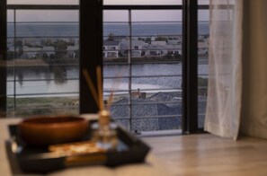 Enjoy breathtaking views of the coastal area from this room's large window.
