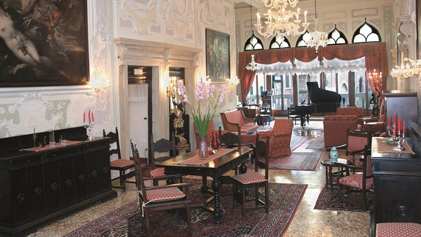 A grand room with ornate decorations, a piano, and a large painting on the wall. - Hotel La Residenza (Venice)