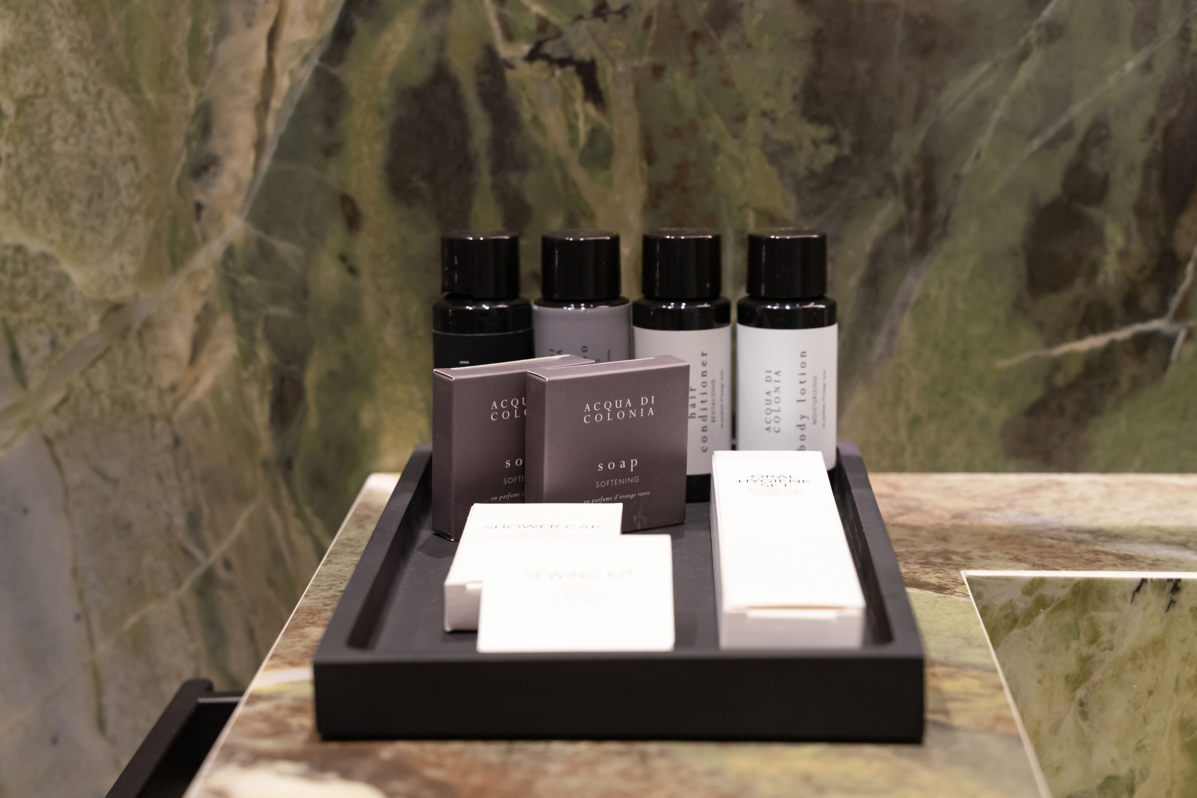 A display of Acqua di Colonia soap products on a marble surface.